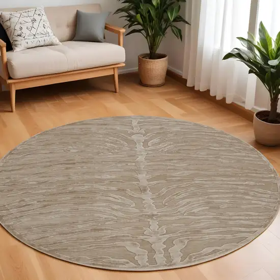 8' Tan and Ivory Animal Print Power Loom Round Rug Photo 1