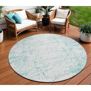 Photo of 8' Teal Blue And Ivory Round Abstract Washable Indoor Outdoor Area Rug