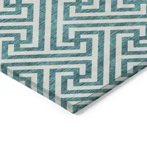 Photo of 8' Teal Blue And Ivory Round Geometric Washable Indoor Outdoor Area Rug