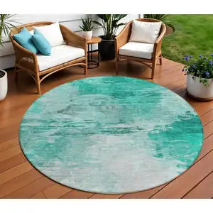 Photo of 8' Teal Blue Aqua And Silver Round Abstract Washable Indoor Outdoor Area Rug