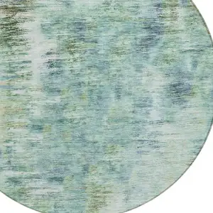 Photo of 8' Teal Blue Green And Ivory Round Abstract Washable Indoor Outdoor Area Rug