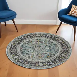 Photo of 6' Teal Blue Orange and Black Floral Distressed Non Skid Round Rug