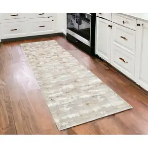 Photo of 3' X 10' Beige Abstract Washable Non Skid Area Rug