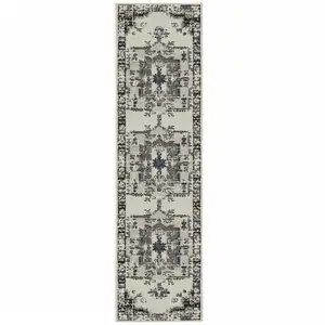 Photo of 2' X 7' Beige Oriental Stain Resistant Indoor Outdoor Area Rug