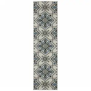 Photo of 2' X 7' Beige Oriental Stain Resistant Indoor Outdoor Area Rug