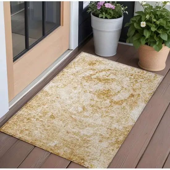 Cream and Gold Abstract Washable Non Skid Indoor Outdoor Area Rug Photo 1