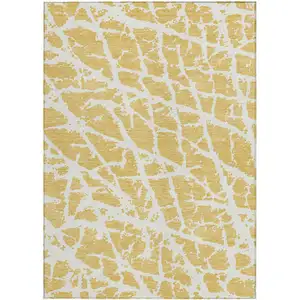 Photo of 3' X 5' Gold and White Abstract Washable Non Skid Indoor Outdoor Area Rug