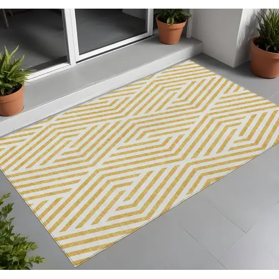 3' X 4' Gold and White Geometric Washable Non Skid Indoor Outdoor Area Rug Photo 1