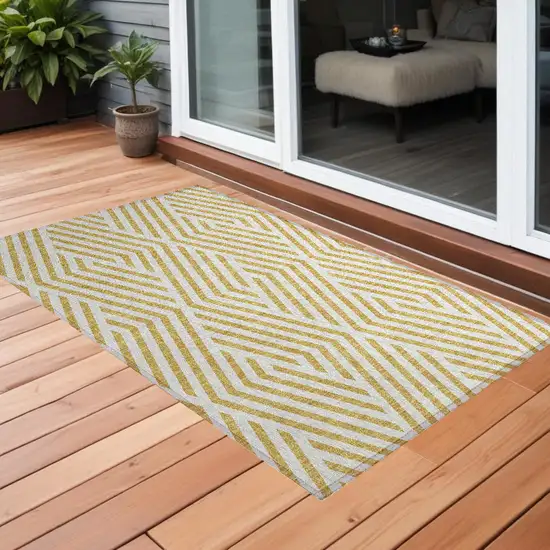 3' X 5' Gold and White Geometric Washable Non Skid Indoor Outdoor Area Rug Photo 1