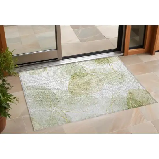 Green and Ivory Abstract Washable Non Skid Indoor Outdoor Area Rug Photo 1