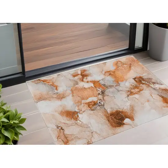 3' X 4' Orange and Ivory Abstract Washable Non Skid Indoor Outdoor Area Rug Photo 1