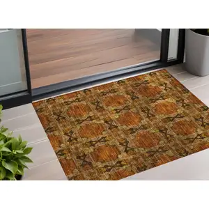 Photo of 3' X 5' Orange and Rust Floral Medallion Washable Non Skid Indoor Outdoor Area Rug