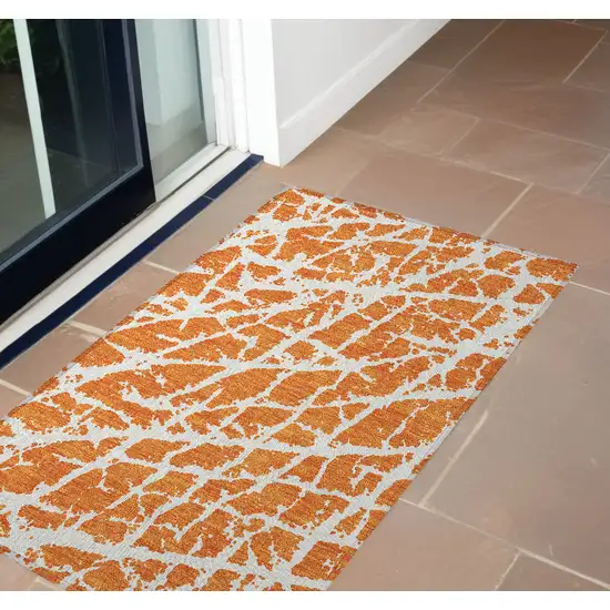 3' X 4' Orange and White Abstract Washable Non Skid Indoor Outdoor Area Rug Photo 1