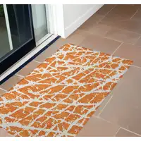 Photo of 3' X 4' Orange and White Abstract Washable Non Skid Indoor Outdoor Area Rug