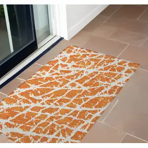 Photo of 3' X 5' Orange and White Abstract Washable Non Skid Indoor Outdoor Area Rug