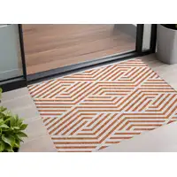 Photo of 3' X 5' Orange and White Geometric Washable Non Skid Indoor Outdoor Area Rug