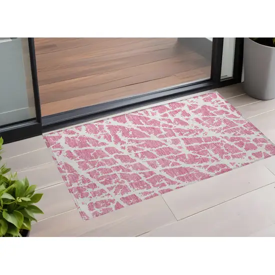 3' X 4' Pink and Ivory Abstract Washable Non Skid Indoor Outdoor Area Rug Photo 1