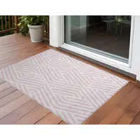 Photo of 3' X 5' Pink and White Geometric Washable Non Skid Indoor Outdoor Area Rug