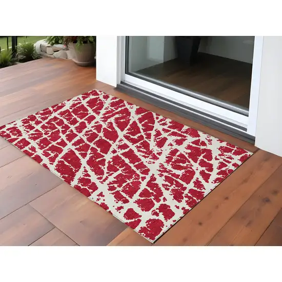 3' X 4' Red and White Abstract Washable Non Skid Indoor Outdoor Area Rug Photo 1