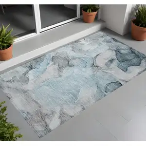 Photo of 3' X 5' Teal Abstract Washable Non Skid Indoor Outdoor Area Rug