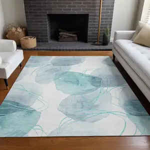 Photo of 3' X 5' Teal and Ivory Abstract Washable Non Skid Indoor Outdoor Area Rug