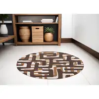 Photo of 5' Yellow and Brown Round Abstract Non Skid Area Rug