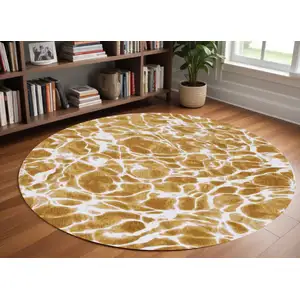 Photo of 8' Yellow and Brown Round Abstract Non Skid Area Rug