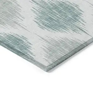 Photo of Aqua Teal Blue And Ivory Ikat Washable Indoor Outdoor Area Rug