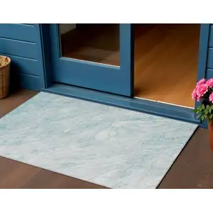 Photo of Aquamarine Aqua And Ivory Abstract Washable Indoor Outdoor Area Rug