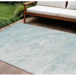 Photo of Aquamarine Aqua And Ivory Abstract Washable Indoor Outdoor Area Rug