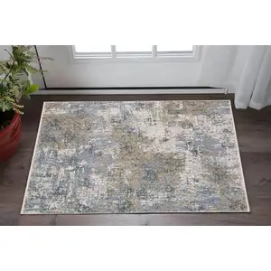 Photo of Beige And Blue Abstract Area Rug With Fringe