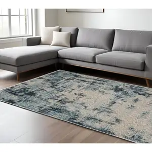 Photo of Beige And Blue Abstract Distressed Area Rug With Fringe