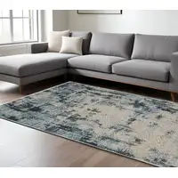 Photo of Beige And Blue Abstract Distressed Area Rug With Fringe