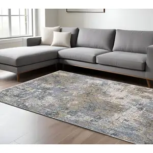 Photo of Beige And Blue Abstract Distressed Area Rug With Fringe