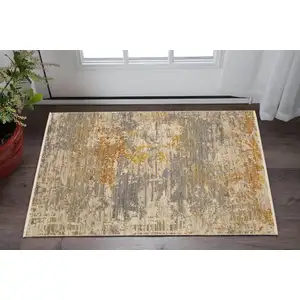 Photo of Beige And Gold Abstract Area Rug With Fringe