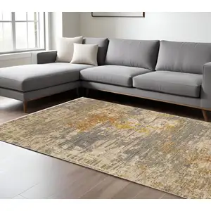 Photo of Beige And Gold Abstract Area Rug With Fringe