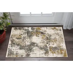 Photo of Beige And Gray Abstract Area Rug With Fringe