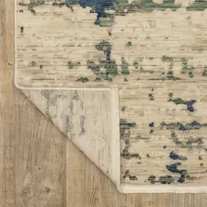 Photo of Beige And Green Abstract Area Rug With Fringe