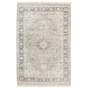 Photo of Beige And Grey Oriental Hand Loomed Stain Resistant Area Rug With Fringe