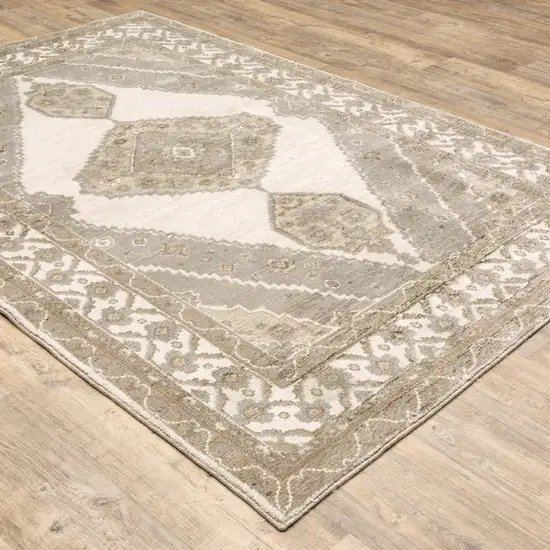 Beige And Ivory Oriental Power Loom Stain Resistant Area Rug Photo 4