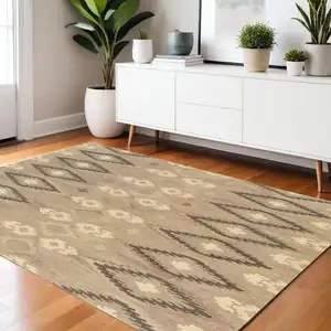 Photo of Beige And Ivory Wool Abstract Hand Tufted Area Rug