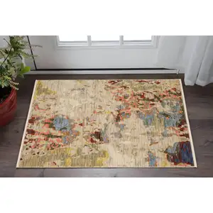 Photo of Beige And Red Abstract Area Rug With Fringe