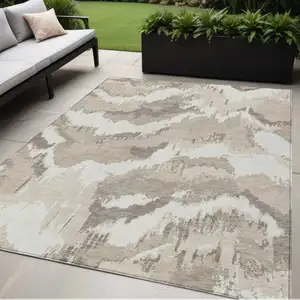 Photo of Beige Brown And Ivory Abstract Washable Indoor Outdoor Area Rug