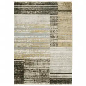 Photo of Beige Charcoal Brown Grey Tan Gold And Blue Geometric Power Loom Stain Resistant Area Rug With Fringe