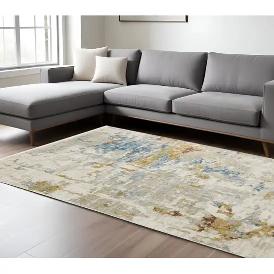 6' X 9' Beige Grey Gold Blue Rust And Teal Abstract Power Loom Stain Resistant Area Rug With Fringe Photo 1