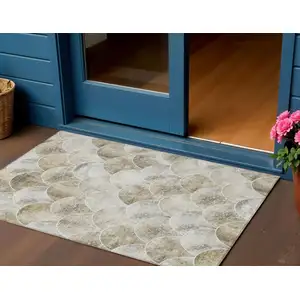 Photo of Beige Ivory And Tan Abstract Washable Indoor Outdoor Area Rug