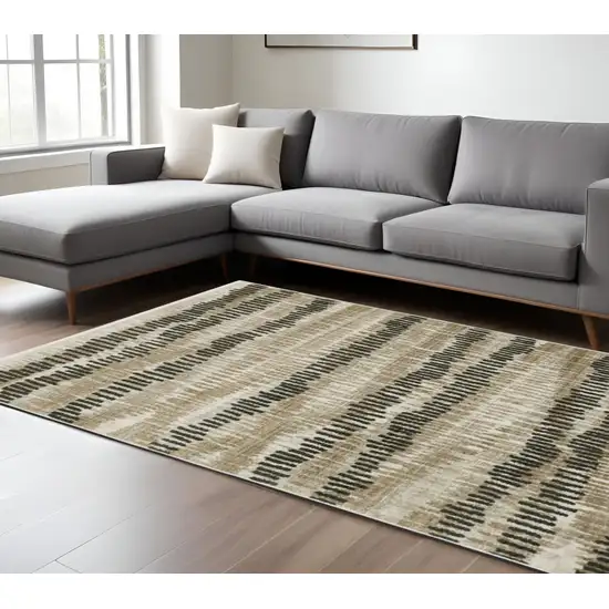 6' X 9' Beige Ivory Charcoal Brown Tan And Grey Abstract Power Loom Stain Resistant Area Rug With Fringe Photo 1