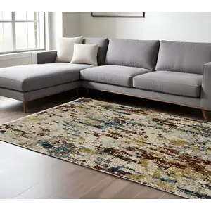 Photo of Beige Rust And Light Blue Abstract Distressed Area Rug With Fringe