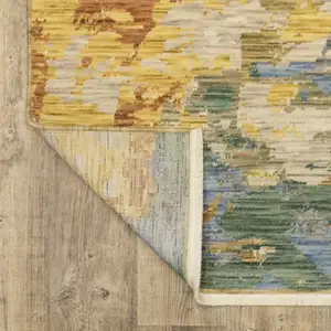 Photo of Beige Rust And Yellow Abstract Area Rug With Fringe