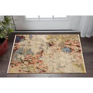 Photo of Beige Salmon And Yellow Abstract Area Rug With Fringe